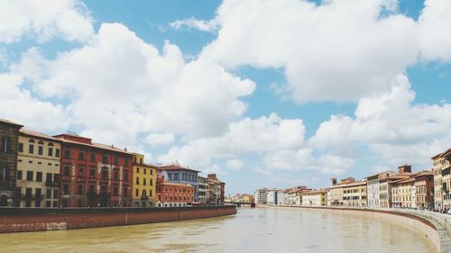 View of canal against cloudy sky