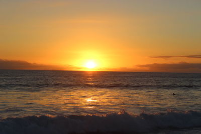 Scenic view of sea against romantic sky at sunset