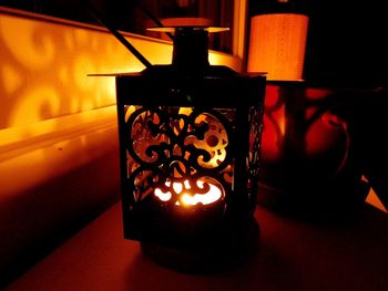 Close-up of illuminated lamp on table