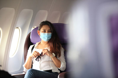 Young woman sitting in airplane