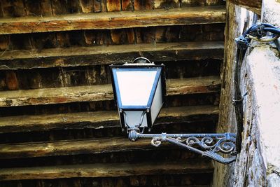 Low angle view of old electric lamp on wall