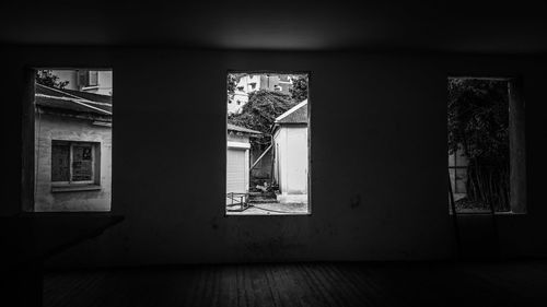 Man standing by window on wall at home