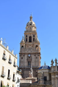 Low angle view of building against clear blue sky