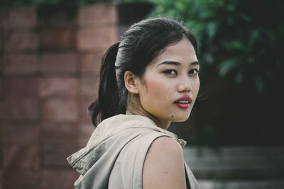 Portrait of young woman standing outdoors