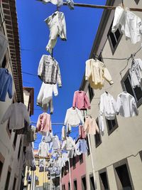 Low angle view of clothes drying on building