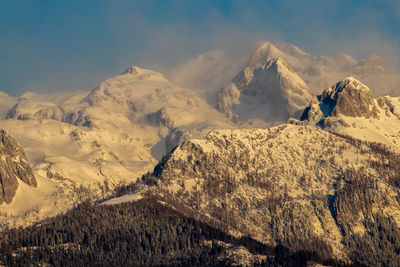 Scenic view of snow covered mountains against sky