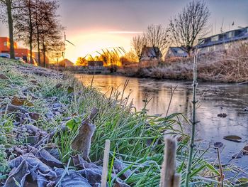 Scenic view of lake against sky at sunset