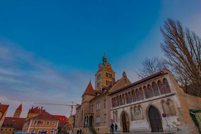 Low angle view of buildings against blue sky