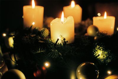 Close-up of lit candles on christmas tree