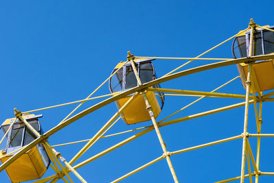 Low angle view of cranes against sky