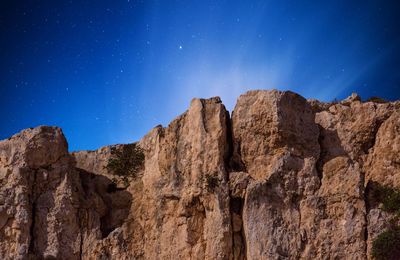 Scenic view of mountains against clear blue sky at night