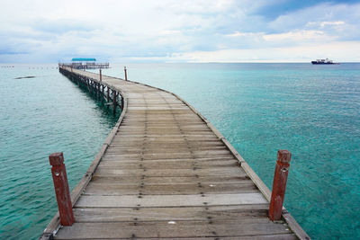 Pier over sea against sky