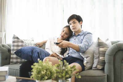 Young man sitting on sofa