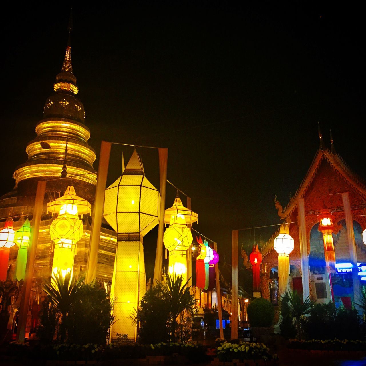 illuminated, night, building exterior, low angle view, architecture, built structure, lighting equipment, religion, place of worship, sky, tree, street light, spirituality, outdoors, clear sky, tradition, cultures, temple - building, decoration