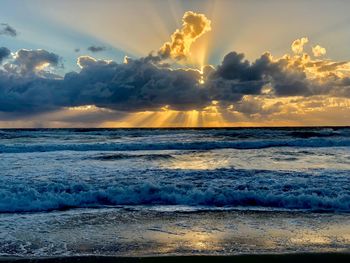 View of sea against cloudy sky during sunset