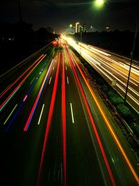 High angle view of light trails on highway at night