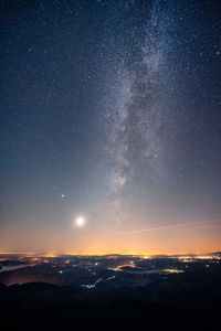 Scenic view of silhouette mountain against sky at night