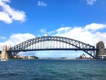 View of bridge over sea against cloudy sky