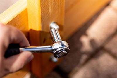 Cropped hand of person holding tool