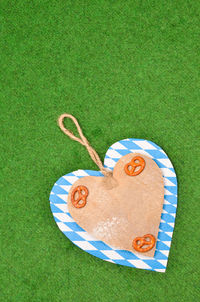 High angle view of heart shape cookies on green lawn