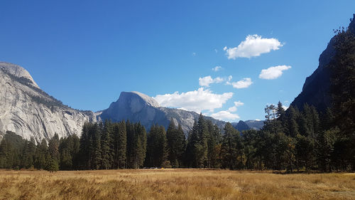 Scenic view of mountains against blue sky