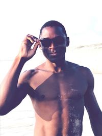 Portrait of young man wearing sunglasses standing outdoors