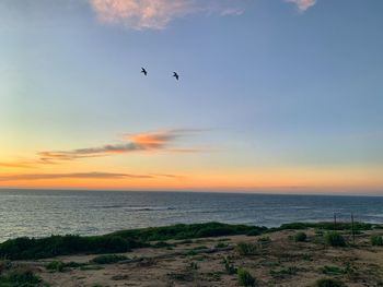 Scenic view of sea against sky during sunset
