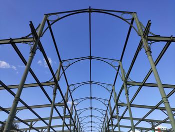 Low angle view of bridge against blue sky