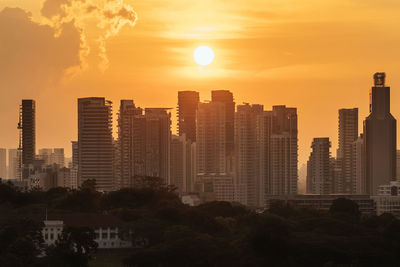 View of modern buildings against sky during sunset