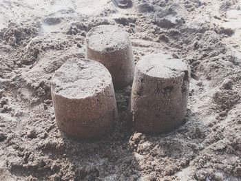 High angle view of human feet on sand