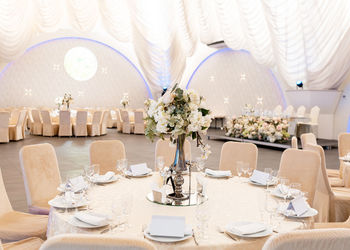 Front view banquet table with decorative flowers in the middle.