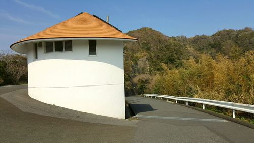 Road by building against sky