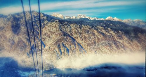 Scenic view of mountains against cloudy sky