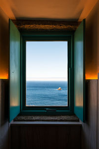 View of sea through window