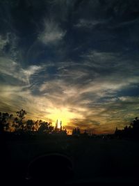 View of road against cloudy sky at sunset