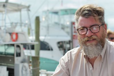 Portrait of man wearing eyeglasses at harbor