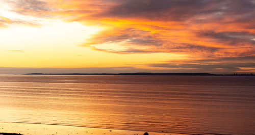 Scenic view of sea against romantic sky at sunset