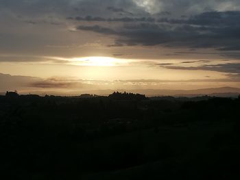 Silhouette landscape against sky during sunset