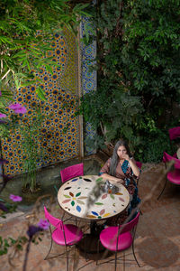 High angle view of girl sitting on table