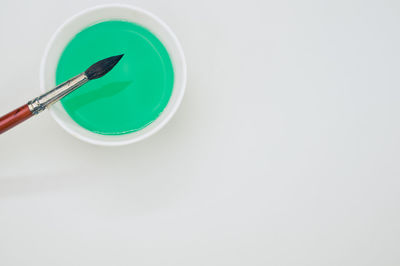 High angle view of blue paint on white table