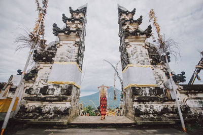 Young woman standing at temple gate