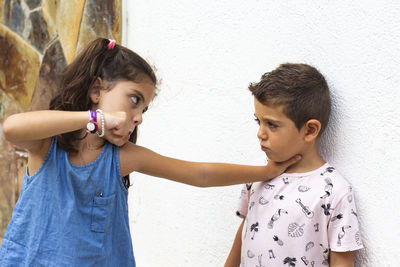 Girl fighting with boy outdoors