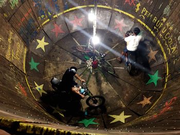 High angle view of people photographing illuminated lamp