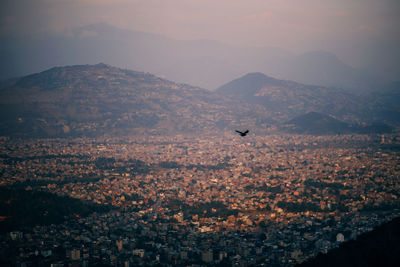 Aerial view of cityscape against sky during sunset