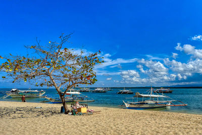 Scenic view of beach against blue sky