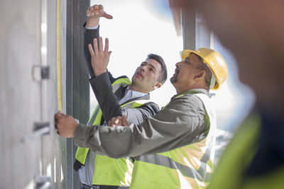 Architect and construction workers on construction site