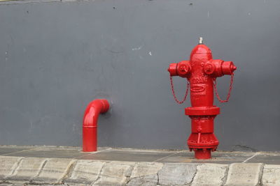 Red fire hydrant on footpath