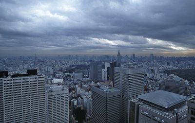 High angle view of cityscape against cloudy sky at dusk