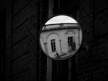 Low angle view of clock on wall of building