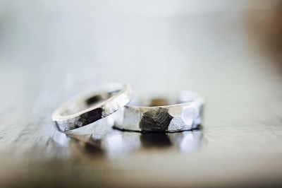 Close-up of wedding rings on table